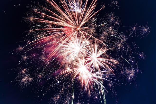 Colorful fireworks bursting in the night sky, illuminating the darkness