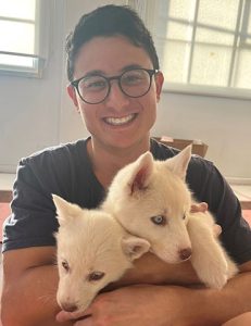 Benjamin Sofaer holding white hair puppies